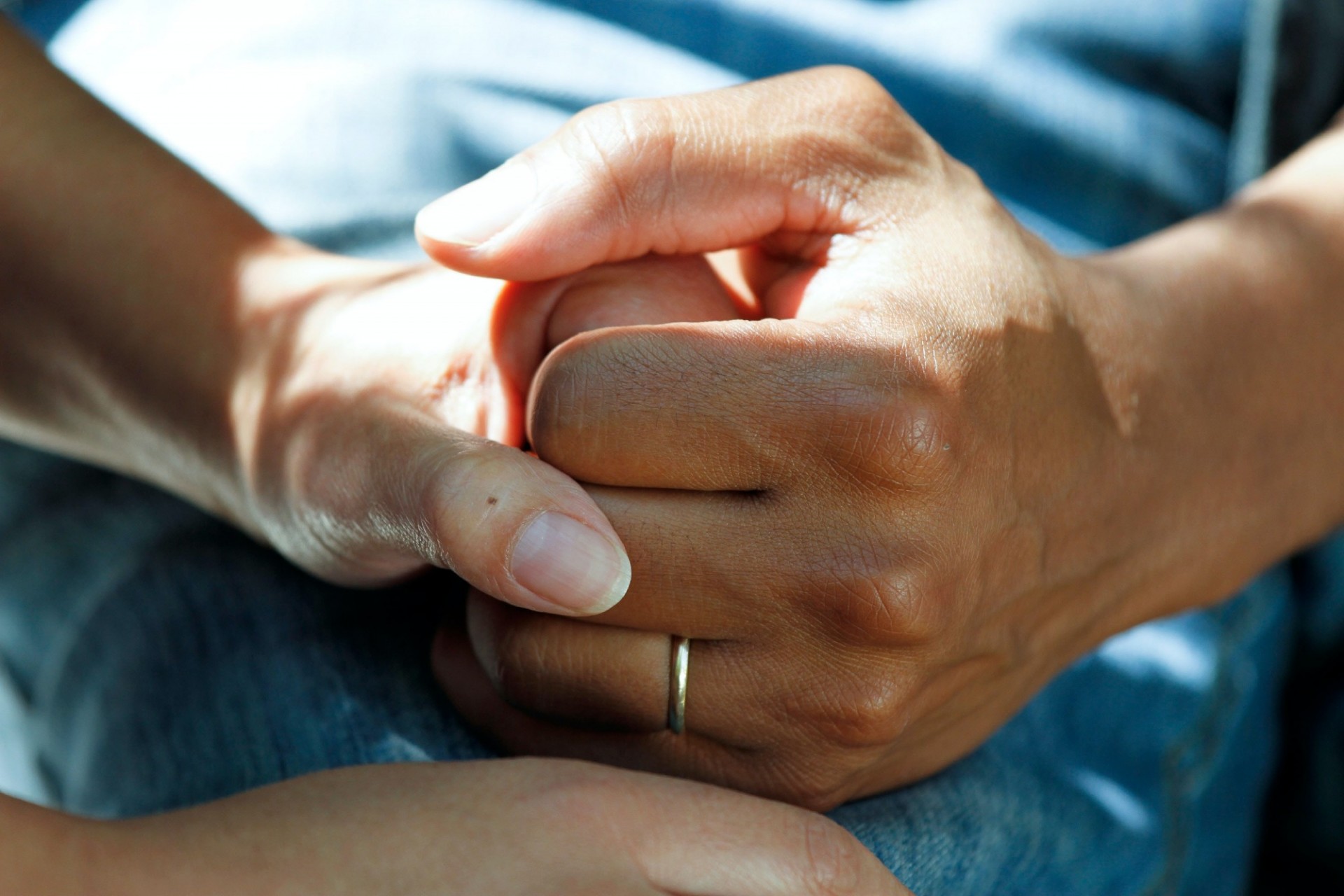 two different people's hands holding each other.